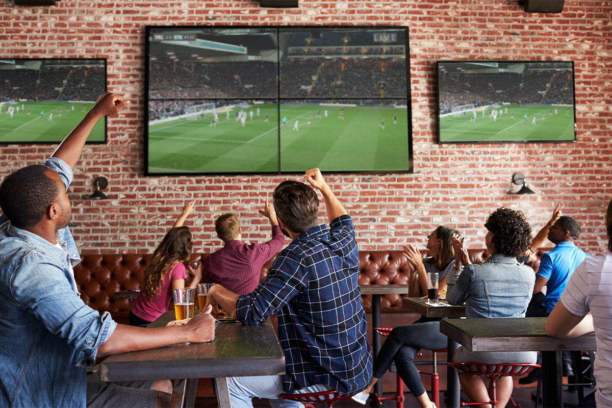 Friends cheering at sports bar