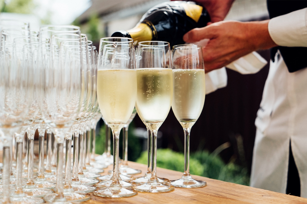 Waiter pouring champagne